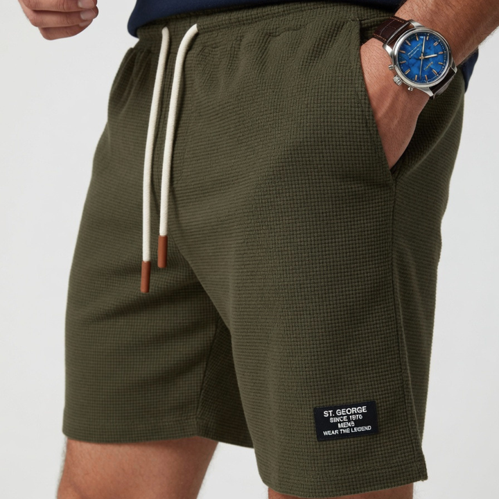 Green men's waffle knit drawstring shorts. Relaxed fit for stylish, comfortable summer fashion.