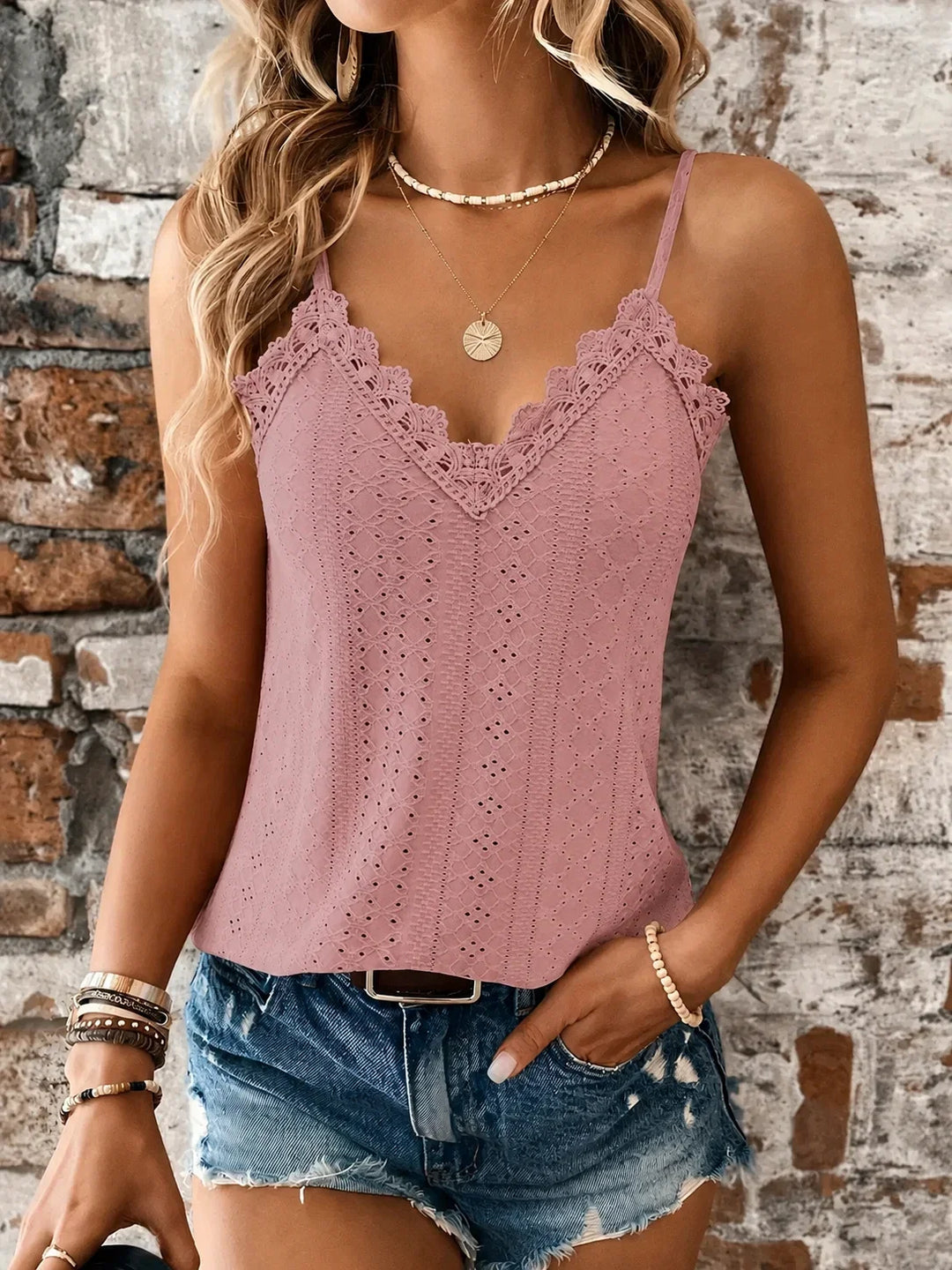 Elegant white camisole with eyelet embroidery, V-neck lace trim & adjustable spaghetti straps.
