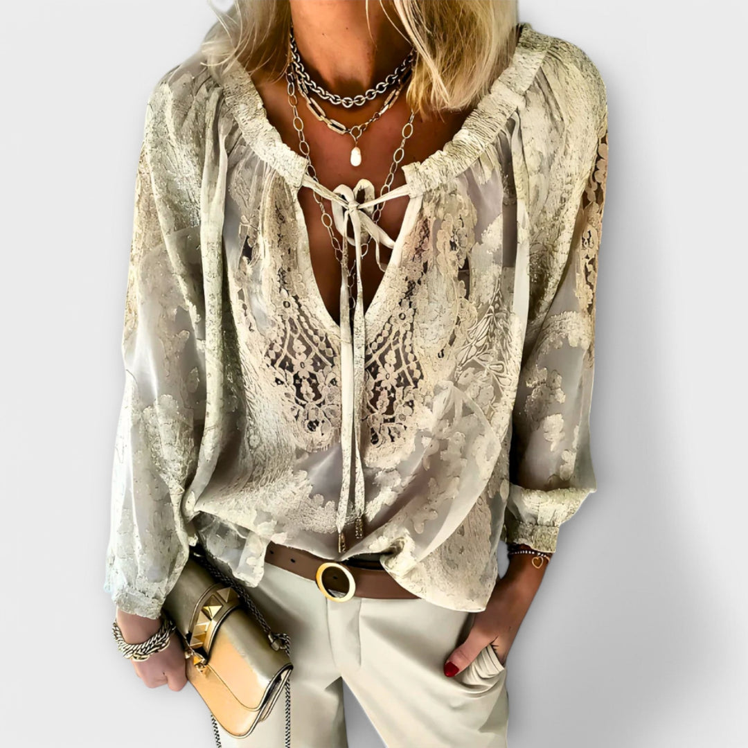 Pink women's lace blouse with tie-neck. Stylish long sleeve top, perfect for sophisticated summer fashion.
