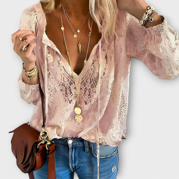 Elegant women's sophisticated lace blouse with tie-neck. Fashionable long sleeve top for versatile spring/summer style.