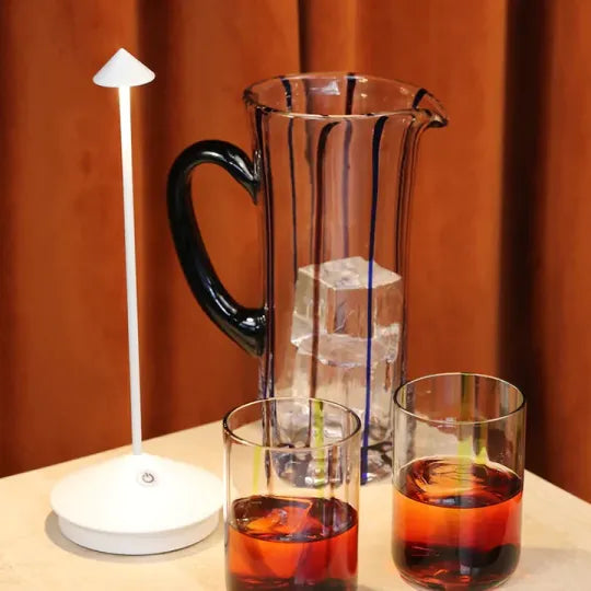 Rechargeable wireless table lamp featuring dimmable LED light. Ideal portable lamp for indoor living or outdoor patios.