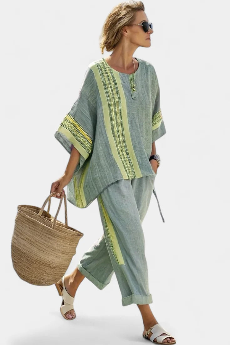 Relaxed fit women's striped two-piece outfit featuring an oversized zip-neck top and comfortable tapered pants.