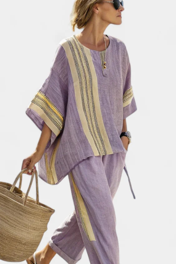 Fashionable women's striped casual set: oversized zip-neck top and versatile tapered pants for comfort.