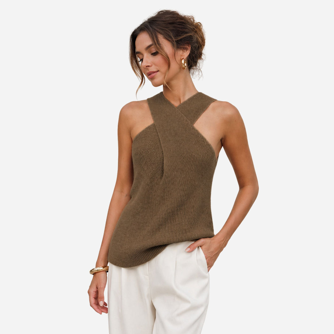 Woman in a stylish black ribbed cross halter tank top, sleeveless & fitted for a sleek summer look.