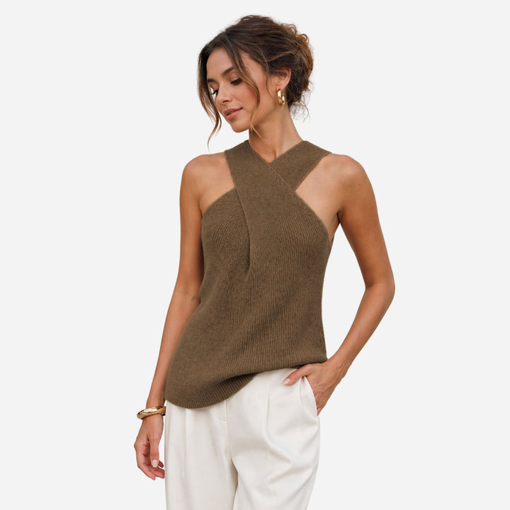 Woman in a stylish black ribbed cross halter tank top, sleeveless & fitted for a sleek summer look.