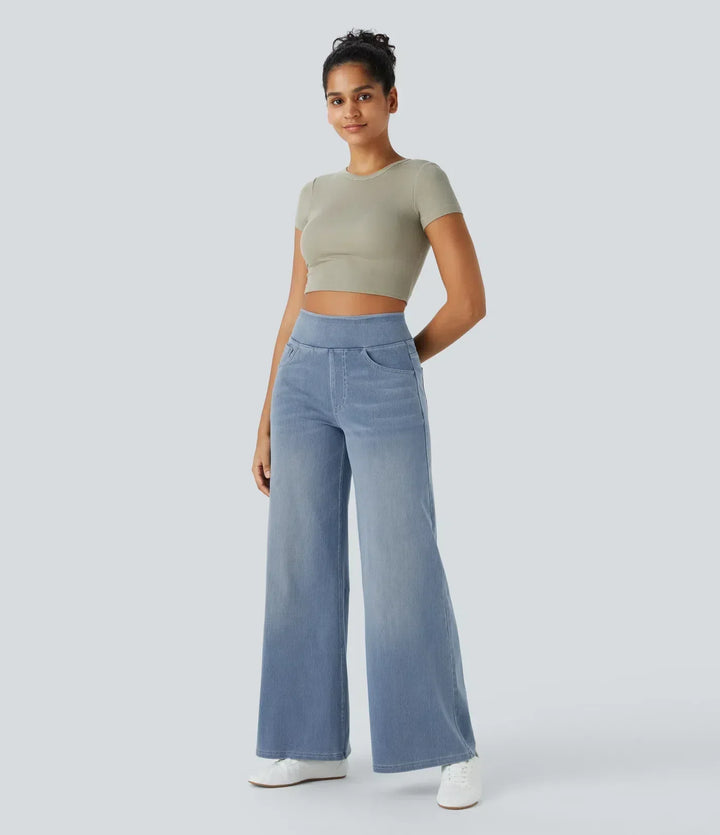 Active woman posing in high-waisted wide-leg stretch trousers, highlighting comfortable stretch fit & flow.