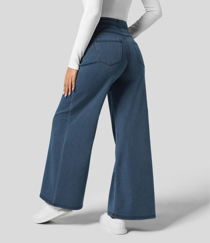 Back view of women's high-waisted wide-leg stretch trousers, showing flowing fabric & comfortable elastic waist.