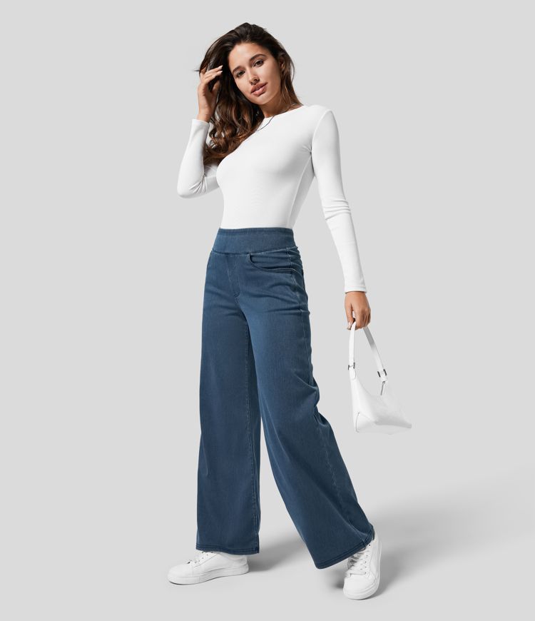 Fashionable woman in high-waisted wide-leg stretch trousers, styled for smart-casual spring/autumn wear.