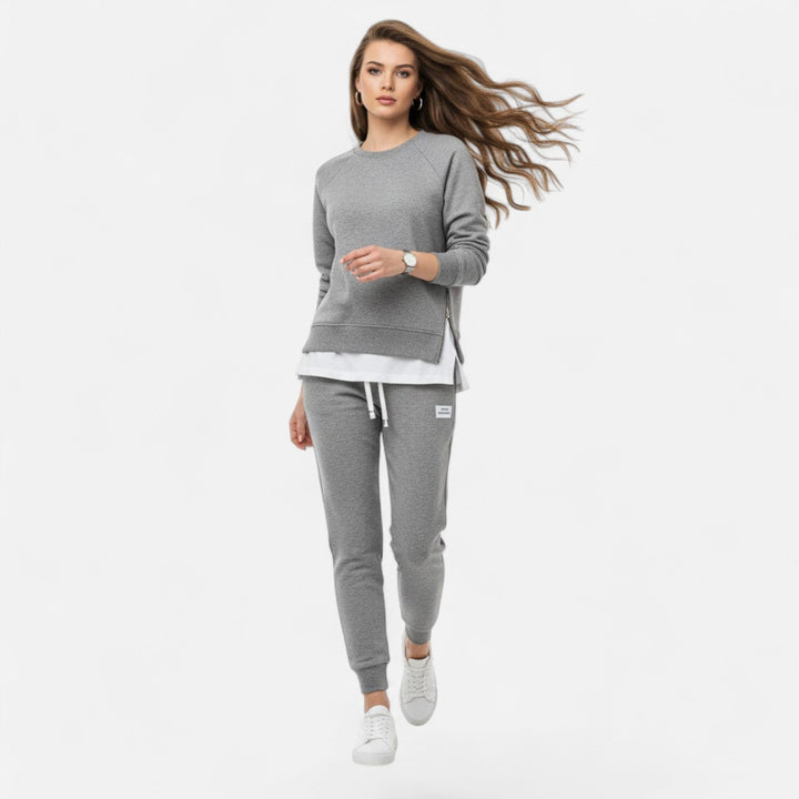 Chic women's two-piece outfit: long-sleeve slit sweatshirt and matching slim pants. Versatile casual wear.