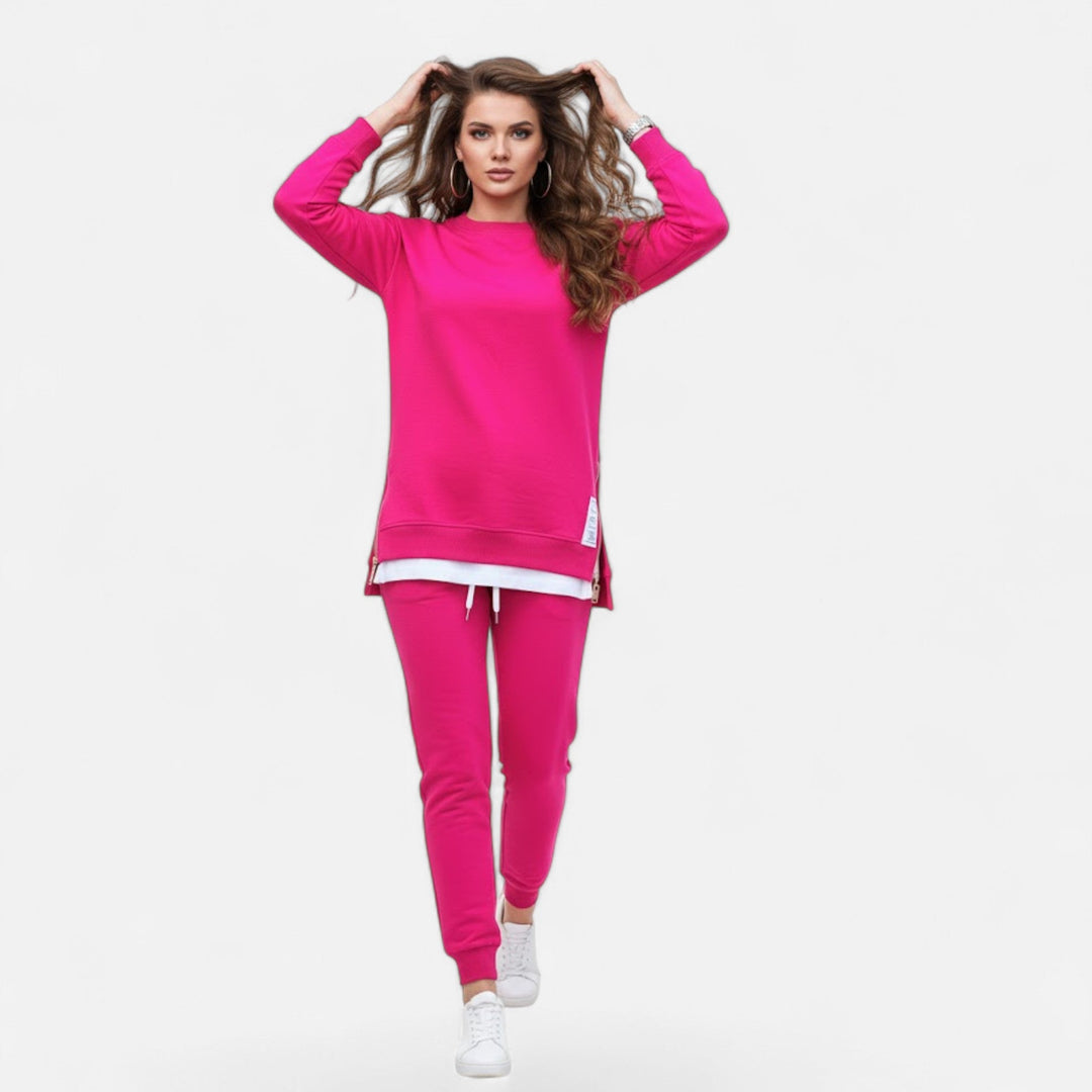 Woman walking in a chic two-piece set: slit sweatshirt and slim pants. Elegant & comfortable women's fashion.