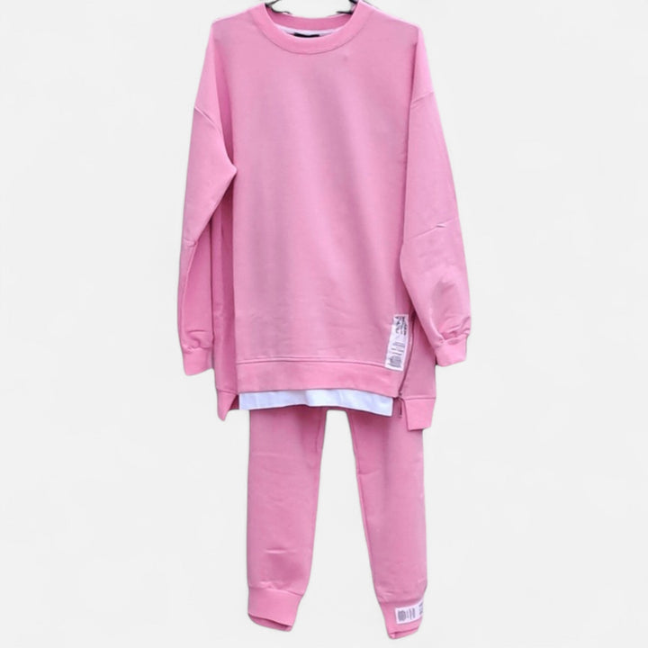 Detail of the slit on a women's chic two-piece sweatshirt set, paired with slim pants. Modern loungewear style.