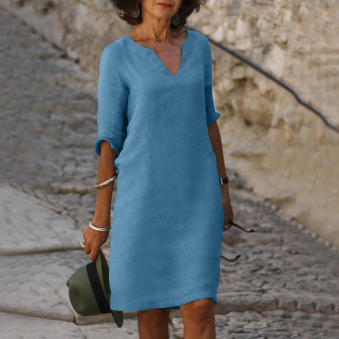 V-neck women's 3/4 sleeve shift midi dress, versatile for all seasons.