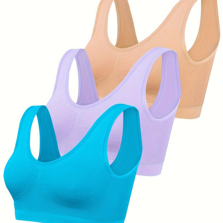 Seamless women's activewear set: supportive sports bra, form-fitting tank, & open-back top, great for gym & yoga.