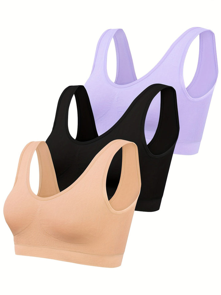 Women's seamless open-back activewear set, includes sports bra & two tank tops for stylish comfort & flexibility.