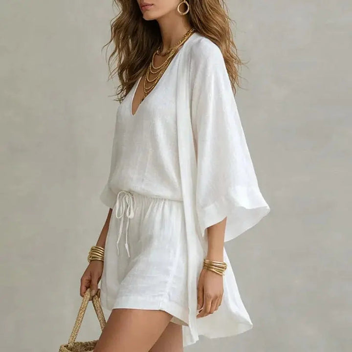 Chic women's linen 3-piece co-ord set: V-neck top, shorts & a versatile layering piece. Ideal for travel & summer.