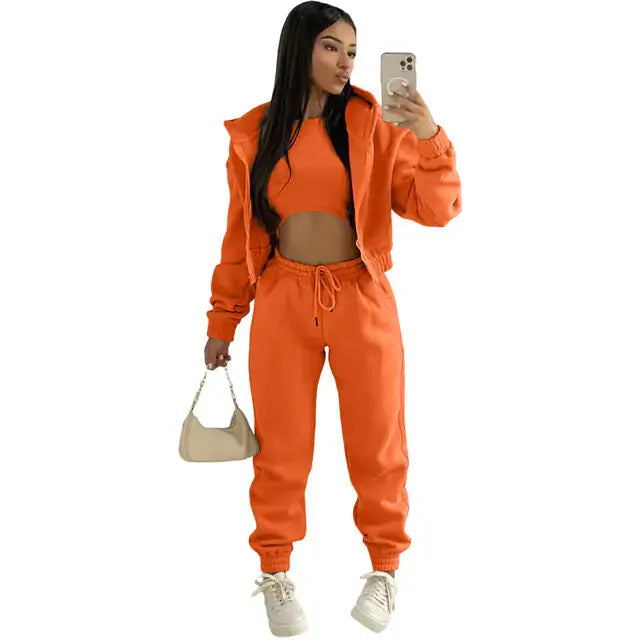 Urban women's streetwear 3-piece set: cropped hoodie, bralette, and joggers.