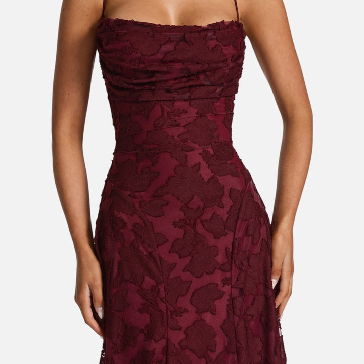 Chic cocktail A-line maxi dress featuring a ruched top & delicate spaghetti straps for a stylish event.