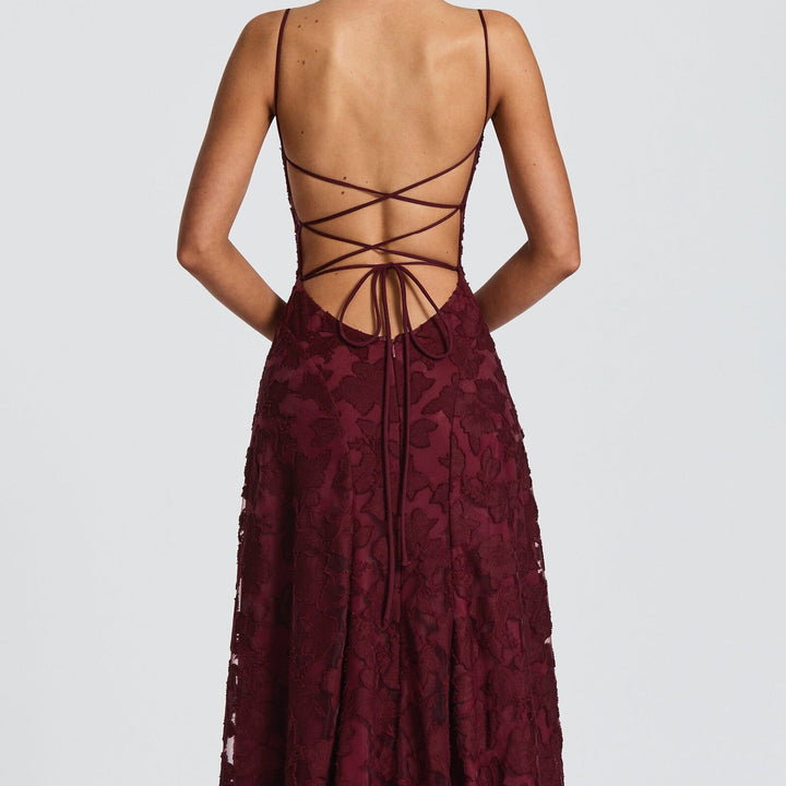 Close-up of ruched bodice & spaghetti straps on an elegant women's A-line maxi dress.