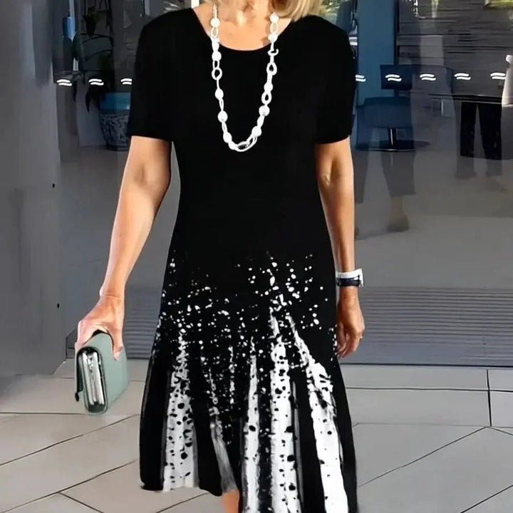 Women's A-Line midi dress with colorful splatter print, short sleeves & flattering fit for summer.