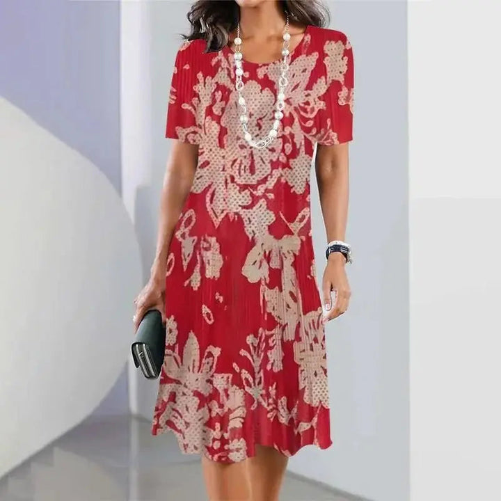 Women's A-Line midi dress in black with red, blue, green splatter print, short sleeves for casual summer style.