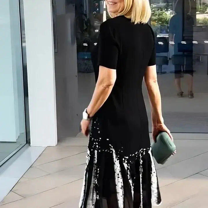 Casual women's A-Line midi dress with a dynamic multi-color splatter print and stylish short sleeves.