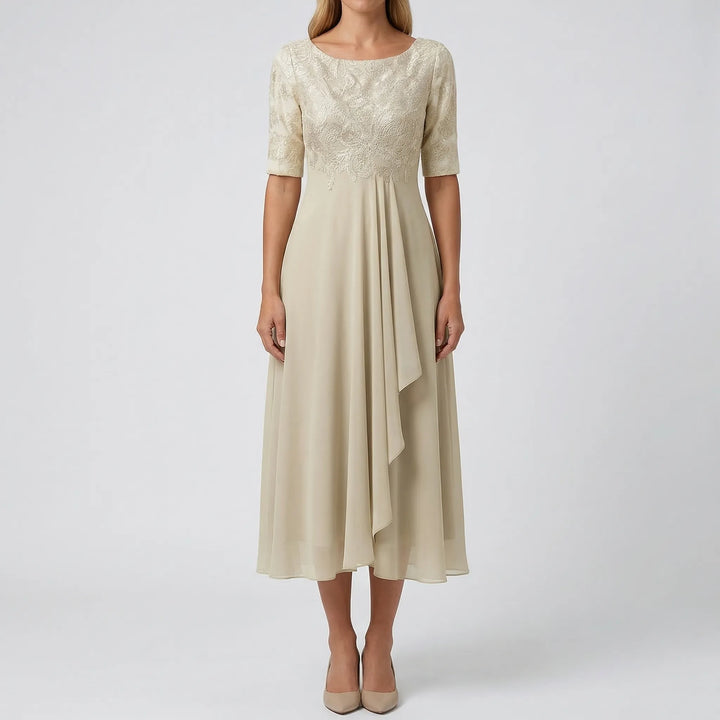 Elegant women's A-line midi dress featuring a beautifully embroidered bodice & floral detail. Relaxed fit.