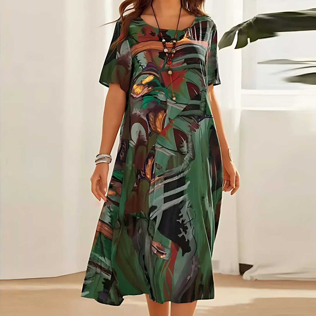 Elegant women's midi dress featuring a vibrant abstract print, short sleeves & a flattering flowy design.