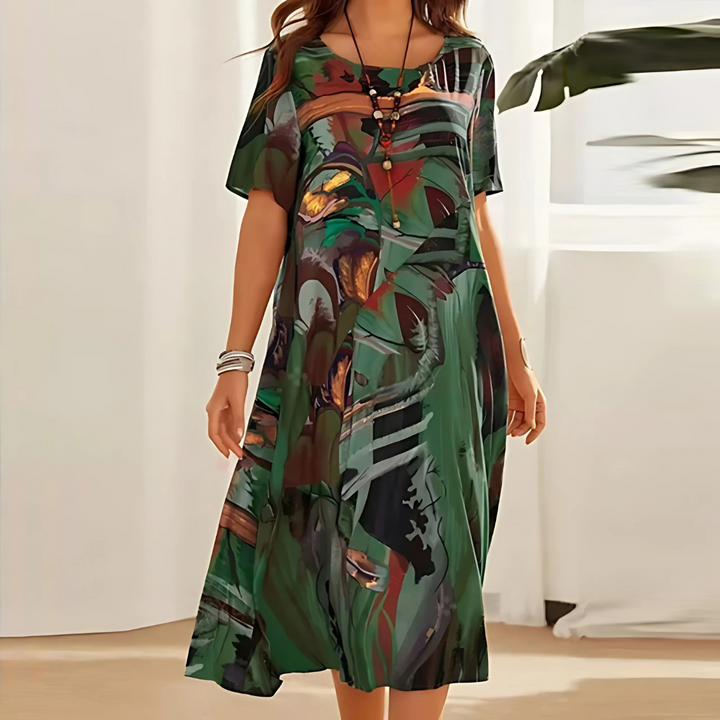 Elegant women's midi dress featuring a vibrant abstract print, short sleeves & a flattering flowy design.
