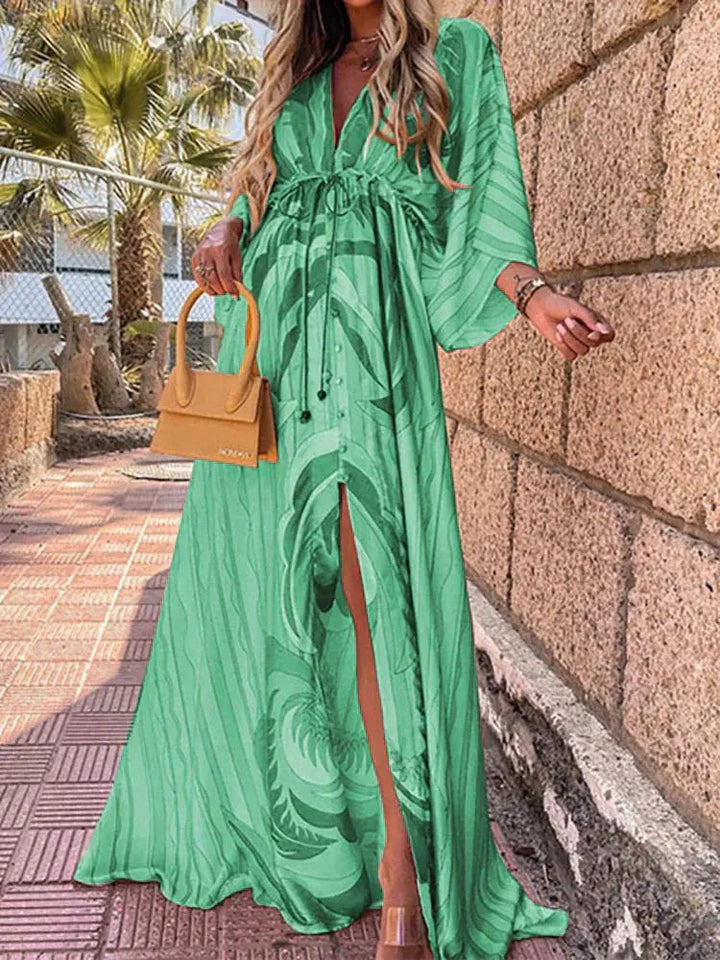 Vibrant abstract print women's maxi dress. Features a V-neck, flowy long silhouette, elegant kimono sleeves, and tie waist.
