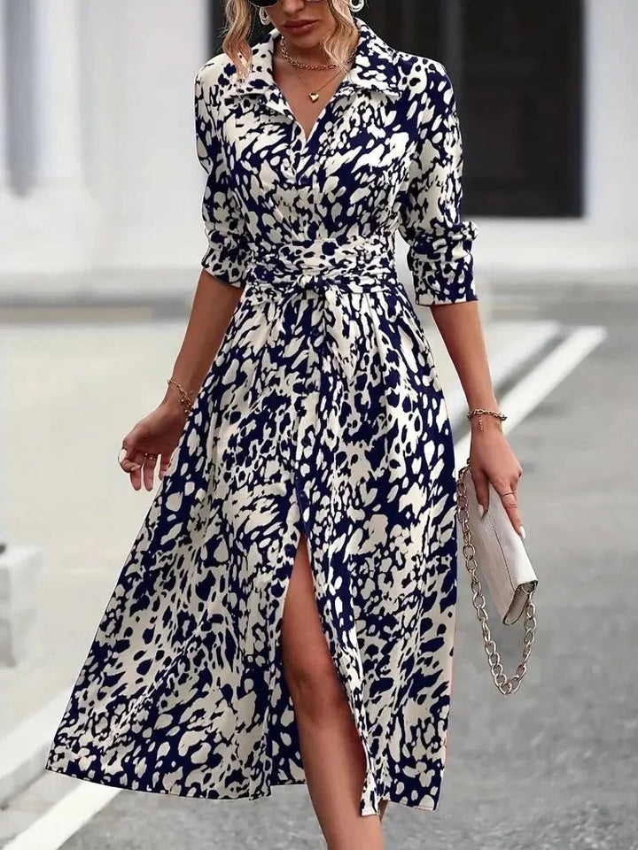 Chic women's abstract print midi shirt dress with 3/4 sleeves & a flattering belt. Button-down, casual elegance.