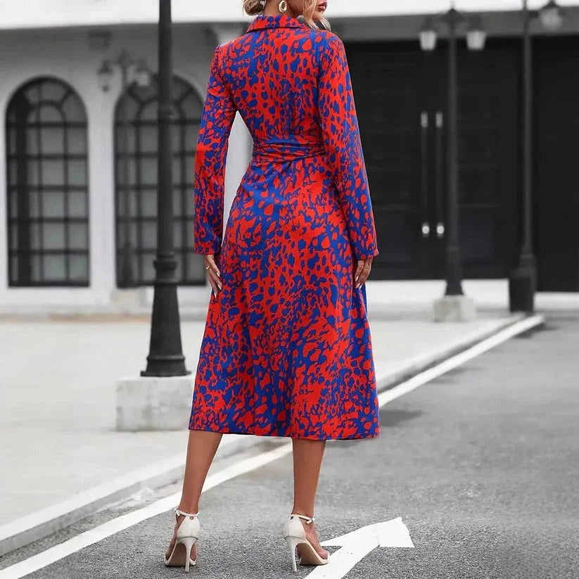 Stylish women's midi dress with a vibrant abstract print and practical 3/4 sleeves. A modern shirt dress design.