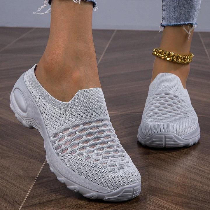 Women's airy slip-on walking sneakers with cushioned heel for comfortable everyday wear.