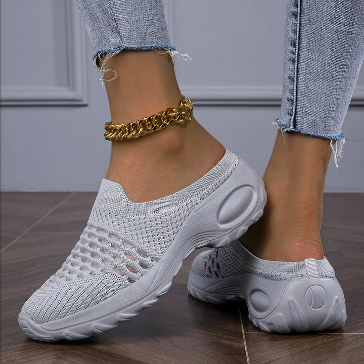 Lightweight women's slip-on sneakers, featuring an airy design and supportive cushioned heel for walking.