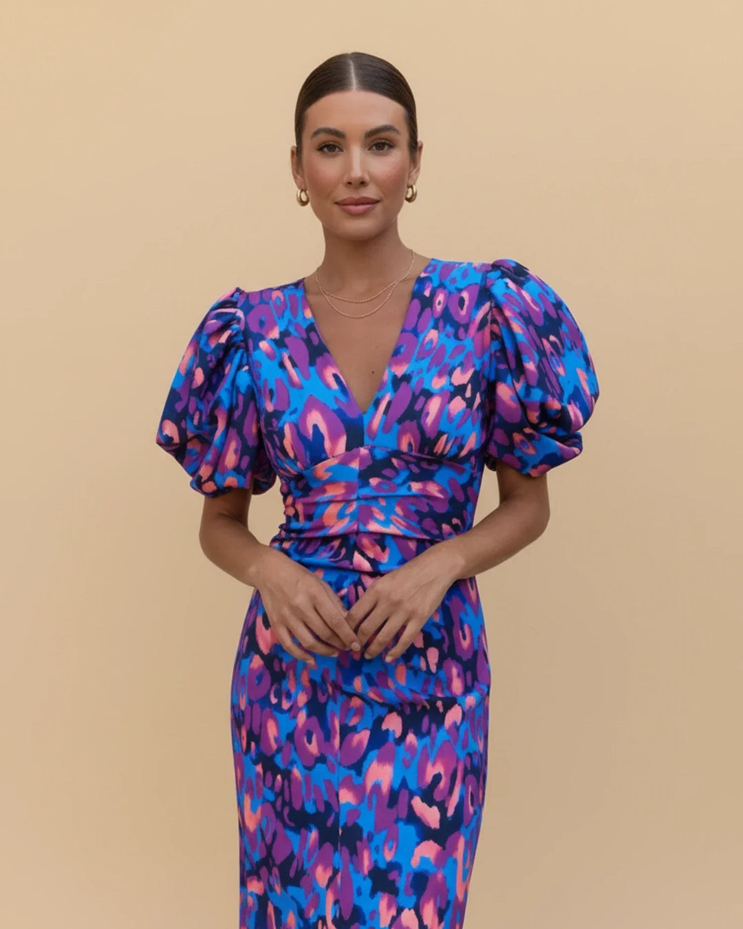 Elegant purple animal print midi dress for women, featuring trendy puff sleeves and a chic V-neck.