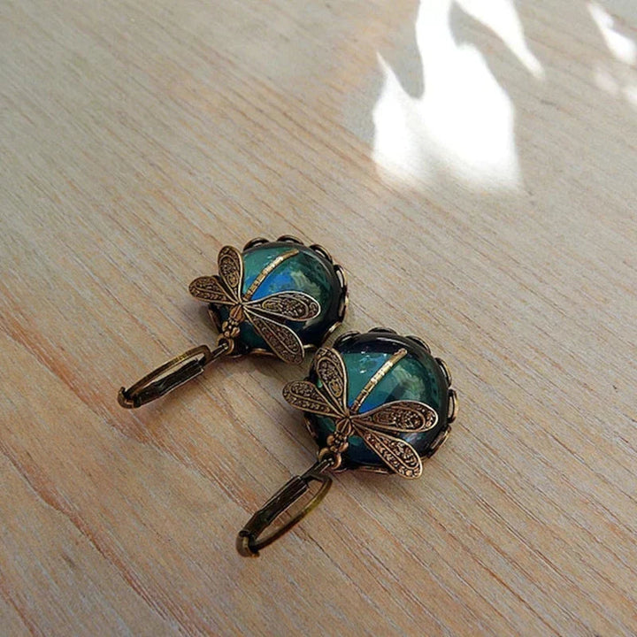 Sparkling crystal dragonfly dangle earrings for women. Unique antique-style jewelry with clear gems.