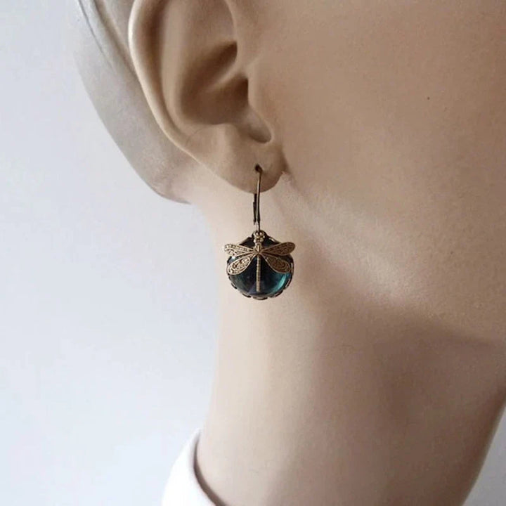 Pair of antique women's earrings featuring delicate crystal dragonflies, elegant and eye-catching dangle design.