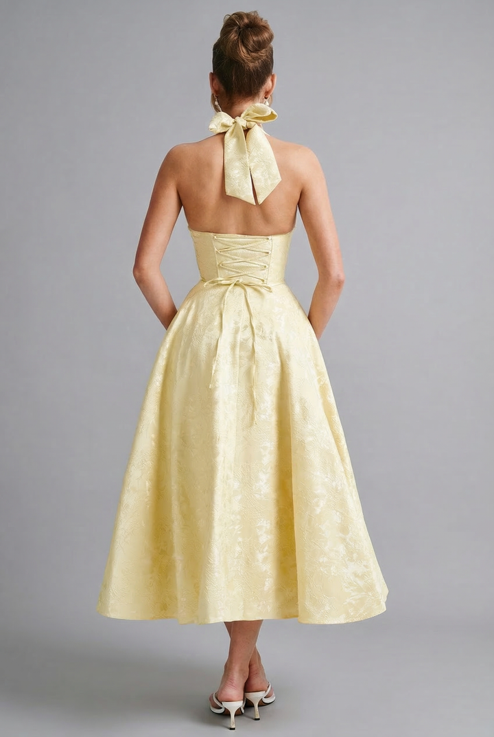 Stylish halterneck midi dress with a fitted corset and ascot bow tie front.