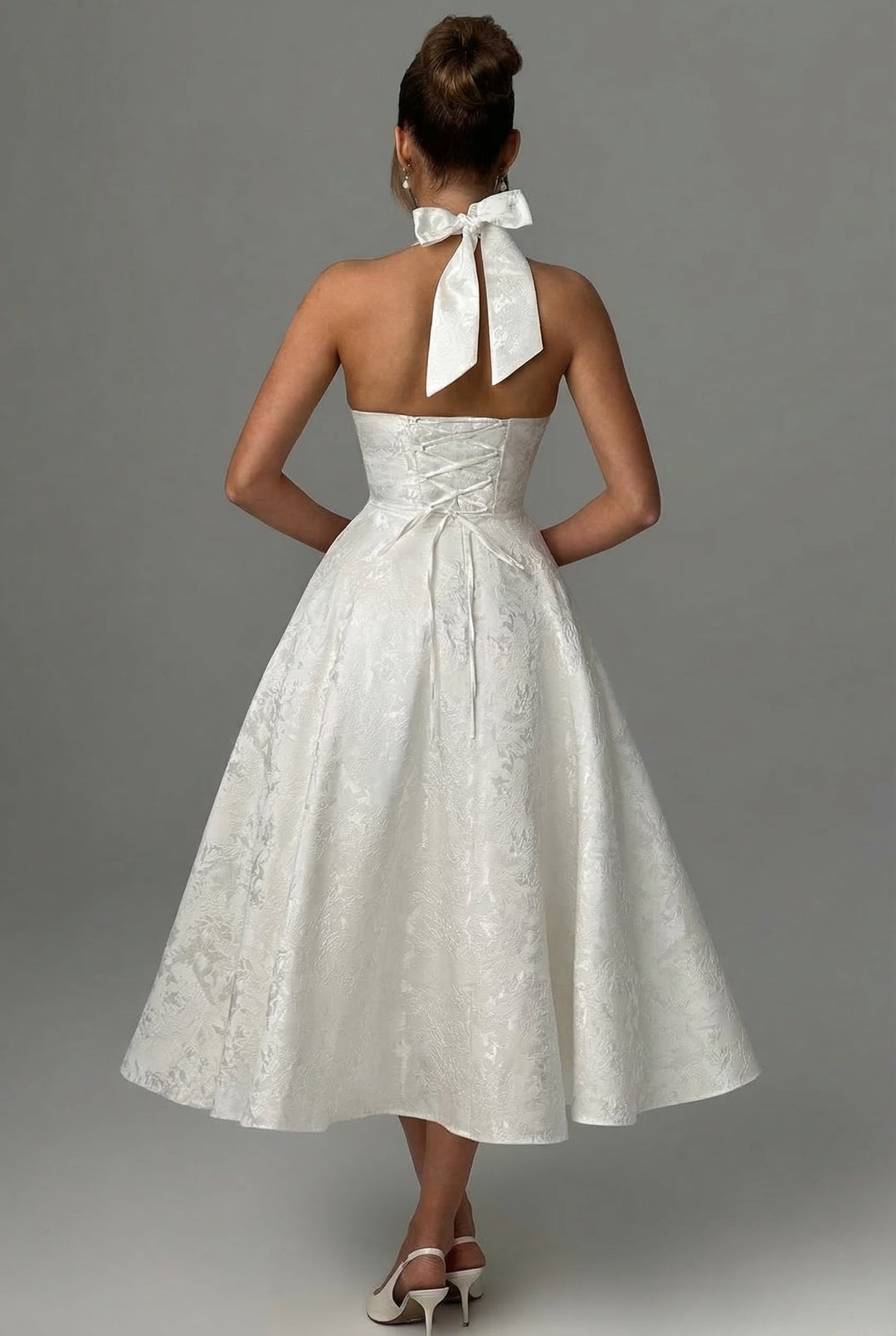 Chic women's corset midi dress featuring a stylish ascot bow tie detail.