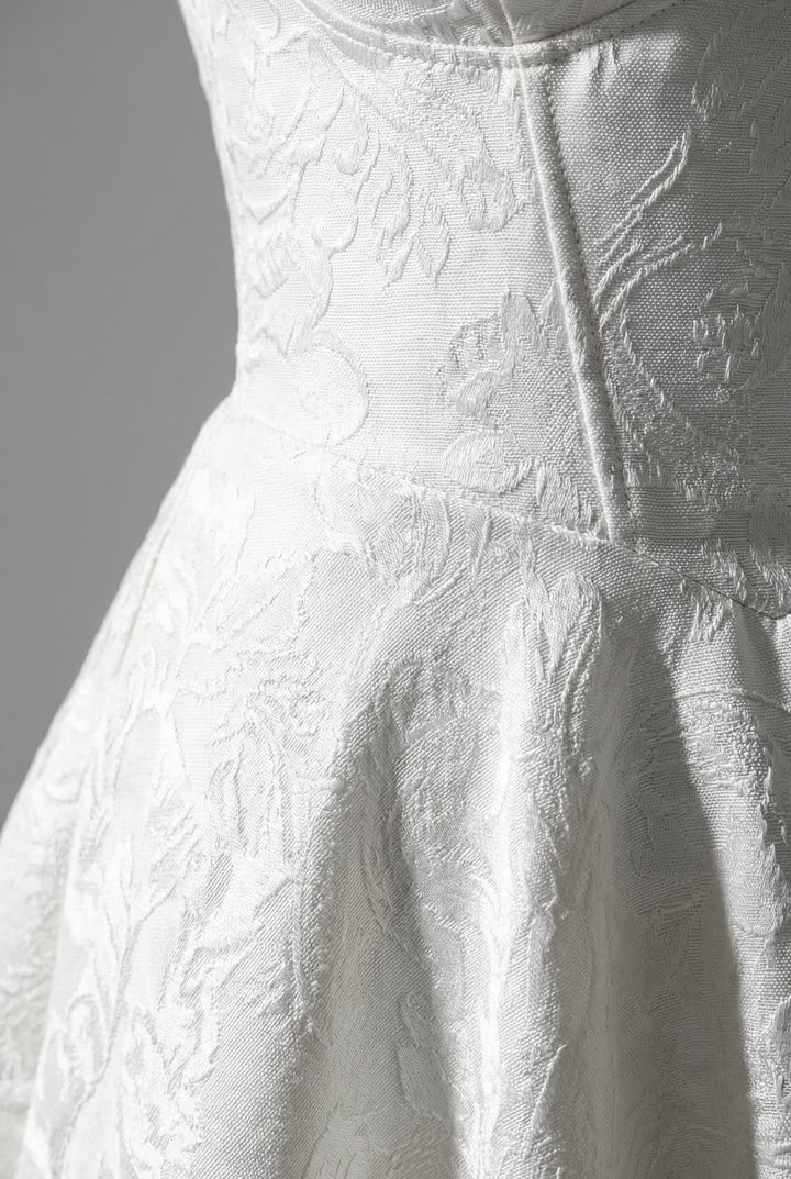 Floral print occasion dress with a sophisticated halterneck and corset design.