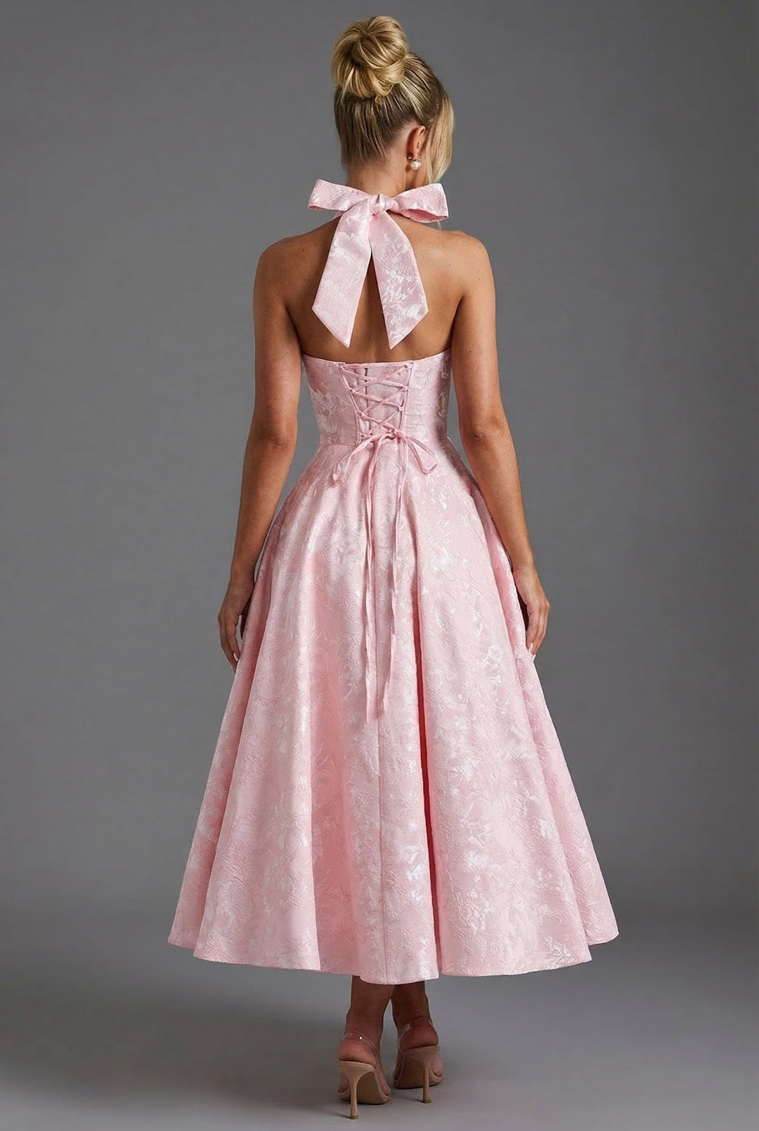 Versatile midi dress with halterneck, corset bodice, and ascot bow tie accent.