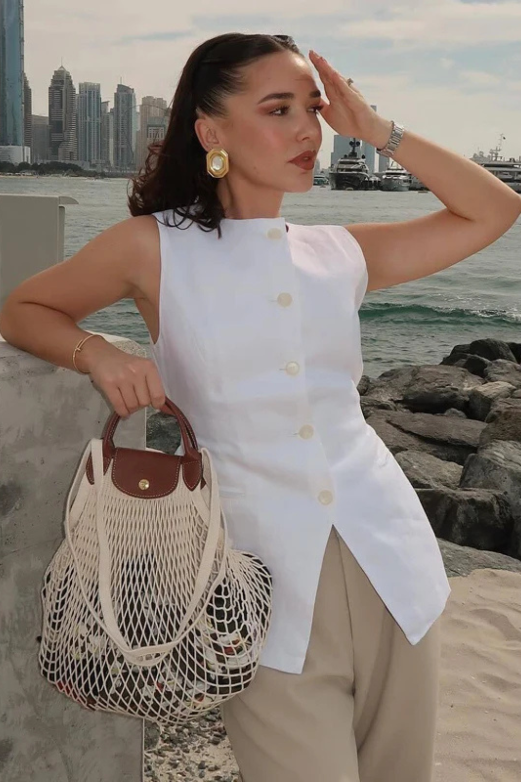 Modern women's sleeveless vest: asymmetric tailored waistcoat with a smart button-front for chic professional looks.