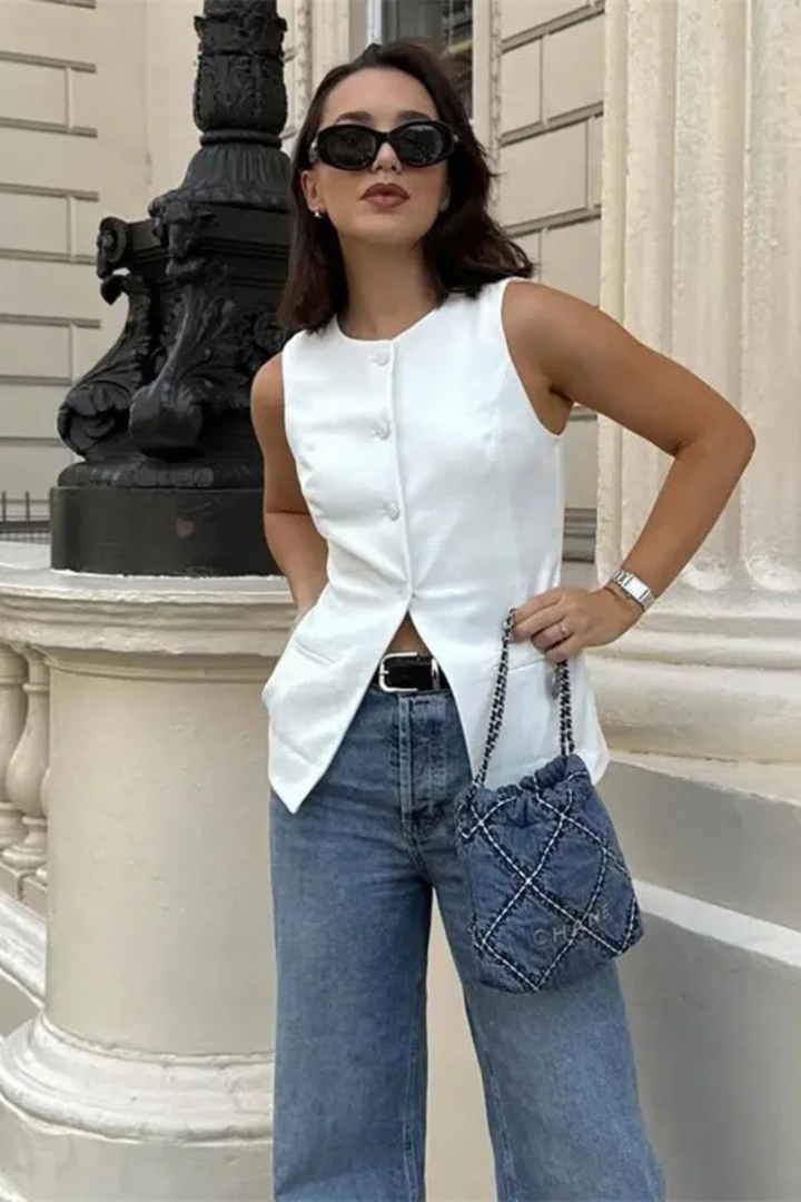 Fashion-forward women's asymmetric waistcoat. Tailored sleeveless vest with button front for elegant, modern style.