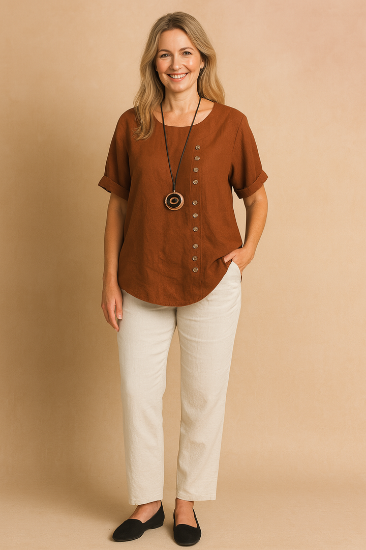 Comfortable women's short-sleeve blouse. Modern asymmetrical cut with an elegant decorative clasp.