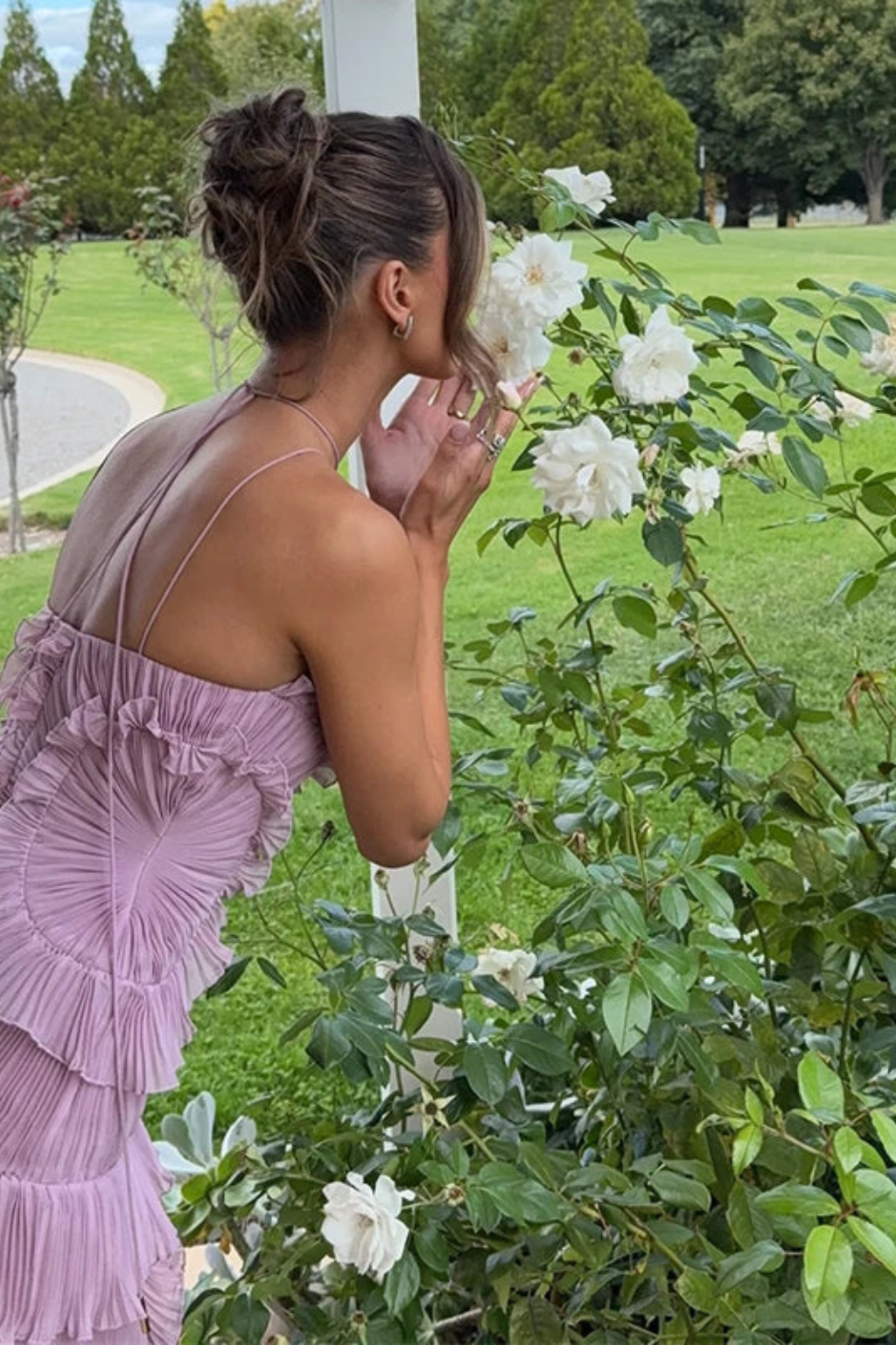 Stylish asymmetric hem maxi dress with backless halter & ruffles, a chic occasion gown.