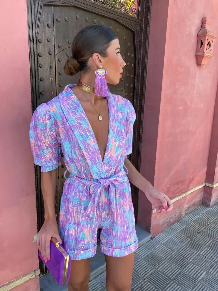 Women's belted puff sleeve romper, perfect for wedding guests. Elegant summer occasion wear.