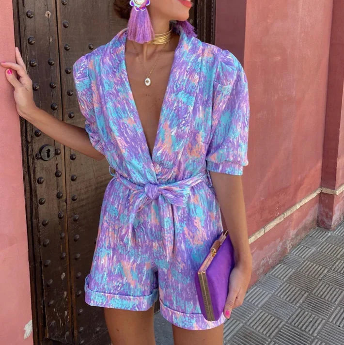 Chic women's puff sleeve romper with belt. Stylish jumpsuit alternative for parties or daytime events.