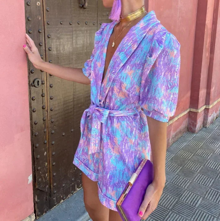 Fashionable women's belted romper featuring puff sleeves. A modern choice for special occasions & events.