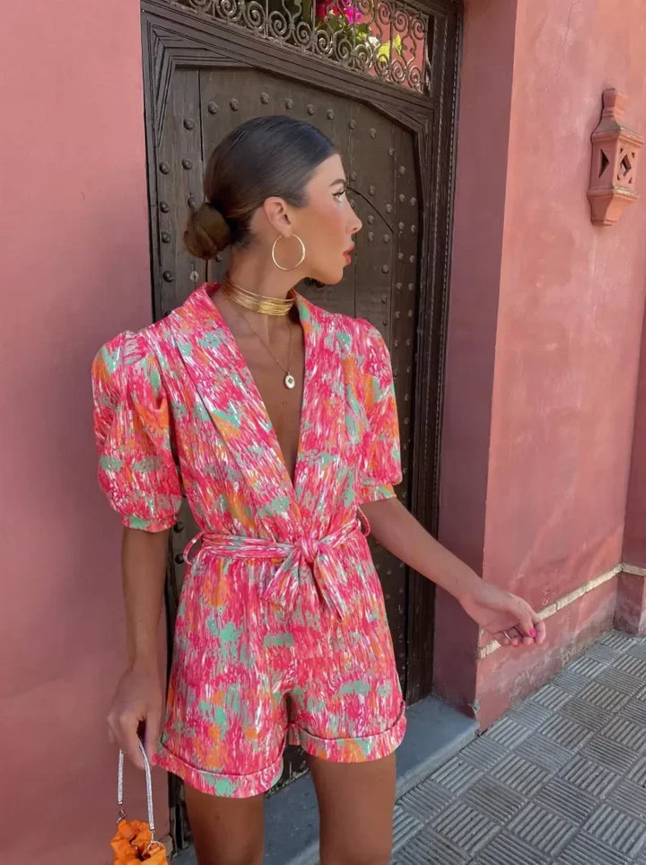 Trendy women's puff sleeve romper with belt, a chic summer outfit. Great for parties or daytime dressy events.