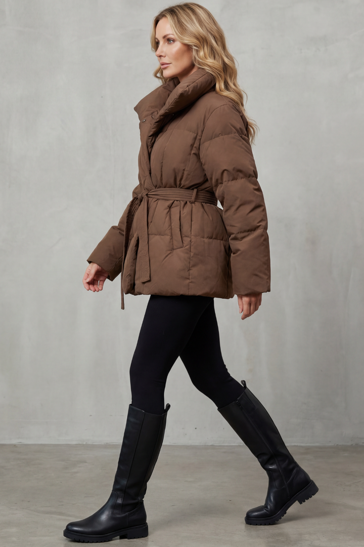 Cozy women's puffer coat, a stylish belted winter jacket providing essential warmth and comfort.