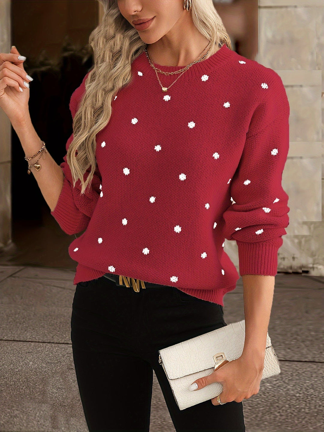Close-up of a soft women's polka dot knit sweater featuring a classic round neck.